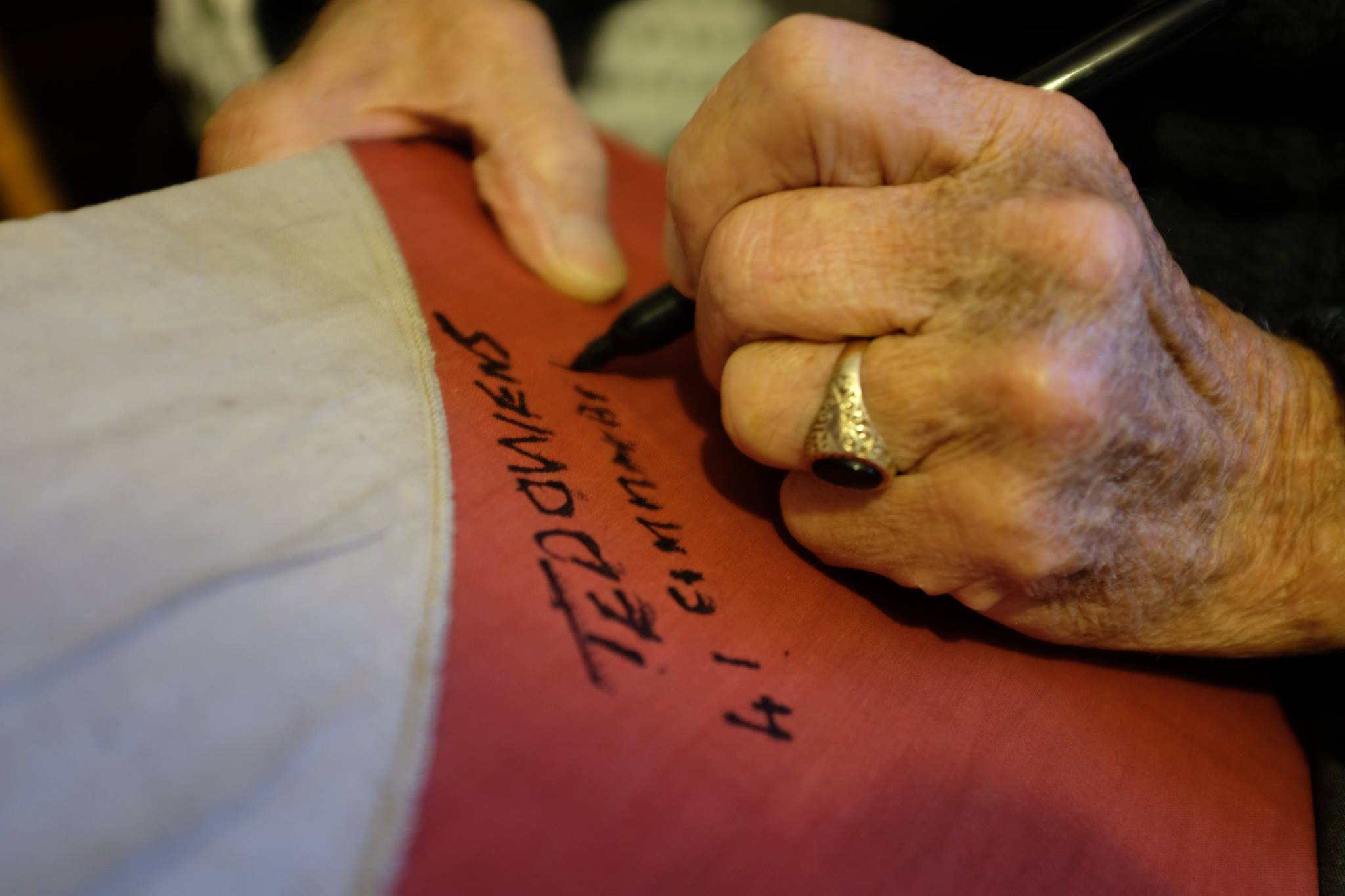 Ted Owens signing a capture flag